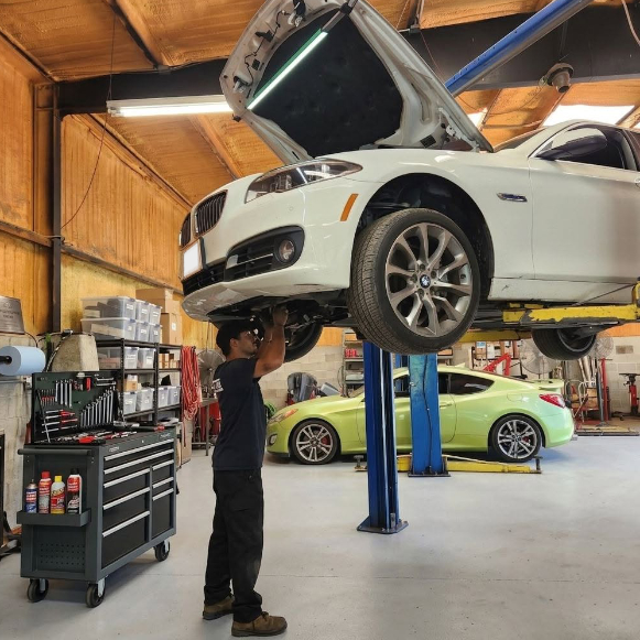 BMW positioned on a car lift for maintenance.